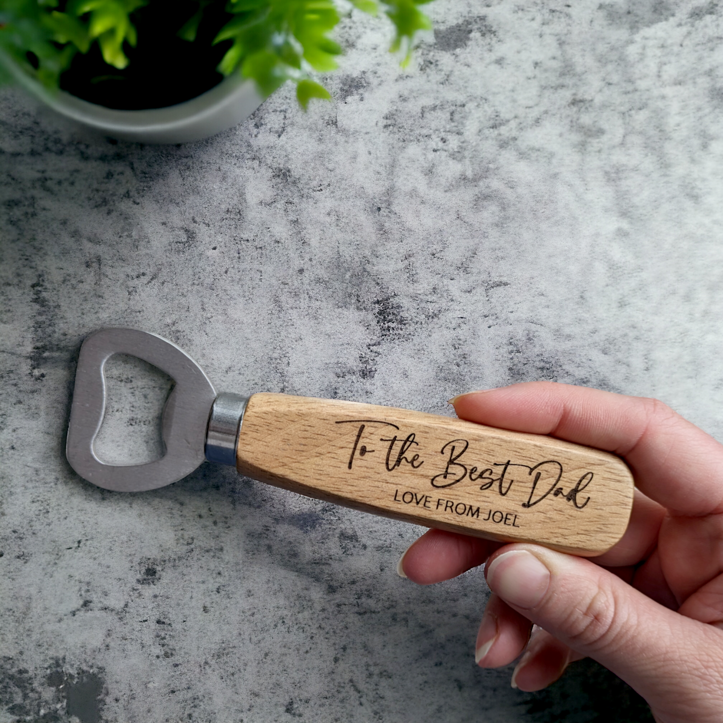 Wooden bottle opener best dad gift held in hand